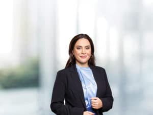 A female executive wearing business clothing in a business school context.