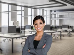 Woman wearing grey suit standing in lecture room